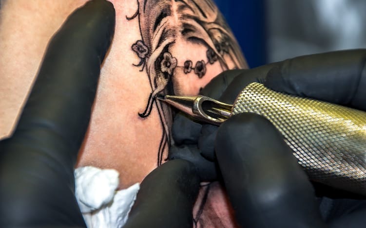 an artist working on a tattoo